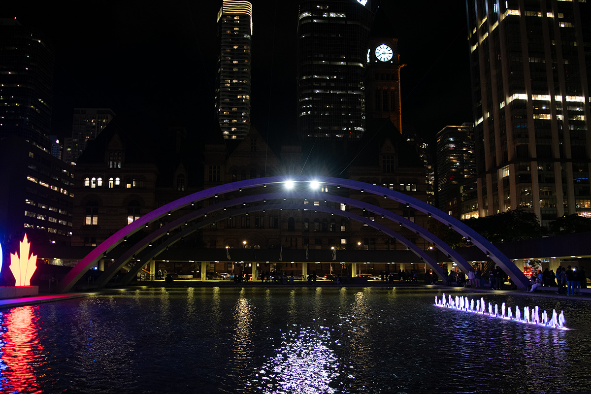 Arches in front of Toronto city hall at night